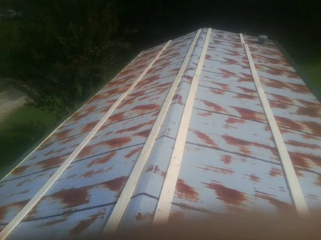 Rusted metal roof panels with new wood purlins before replacement — Storm Damage Roof Repair in Camp Dennison by Roofing Brothers