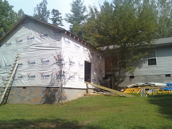 Tyvek wrapped gable on a new room addition beside an existing home in Camp Dennison