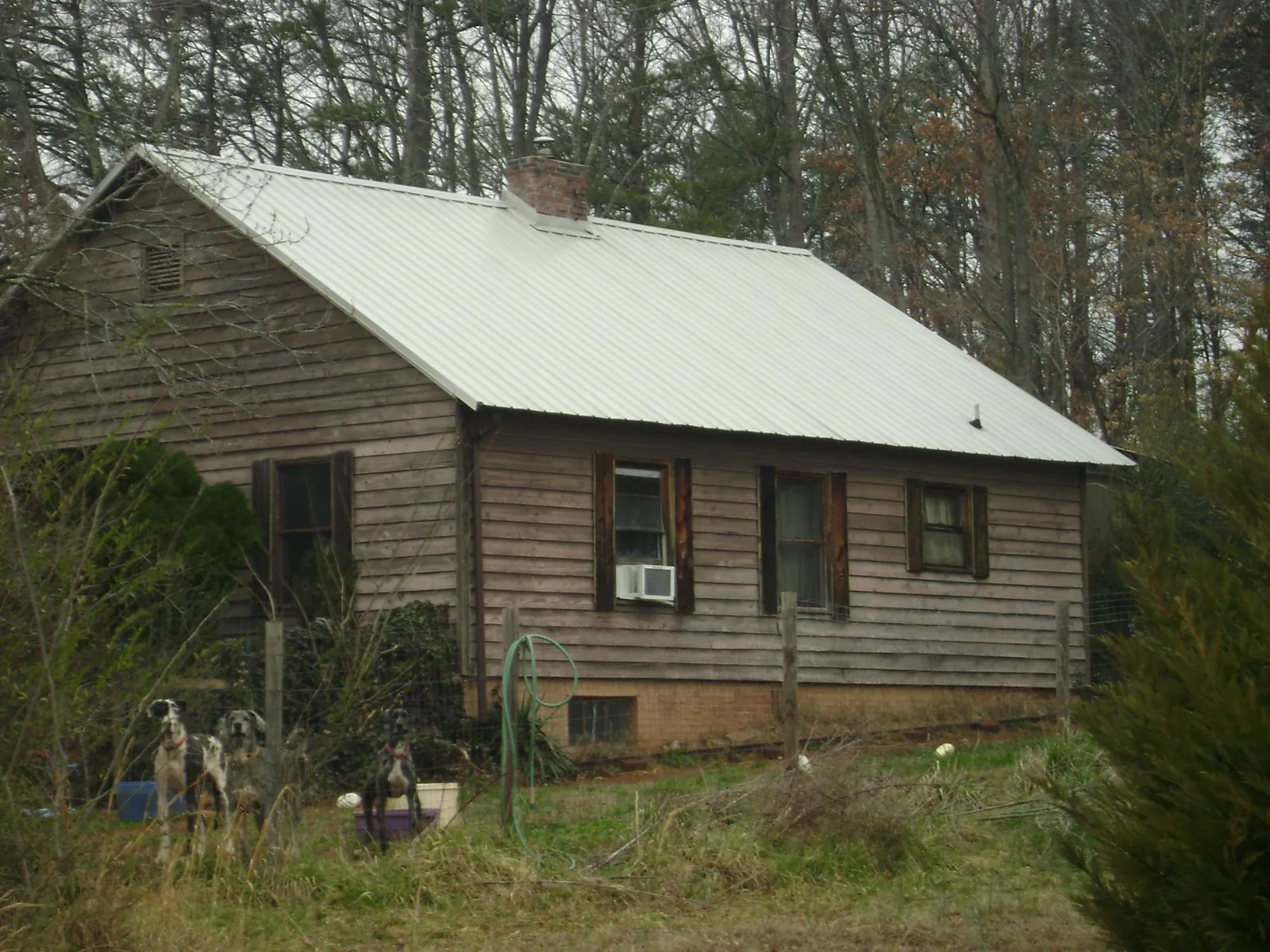 White metal roof on an old wood sided farmhouse, from a Metal Roof Installation job in Camp Dennison